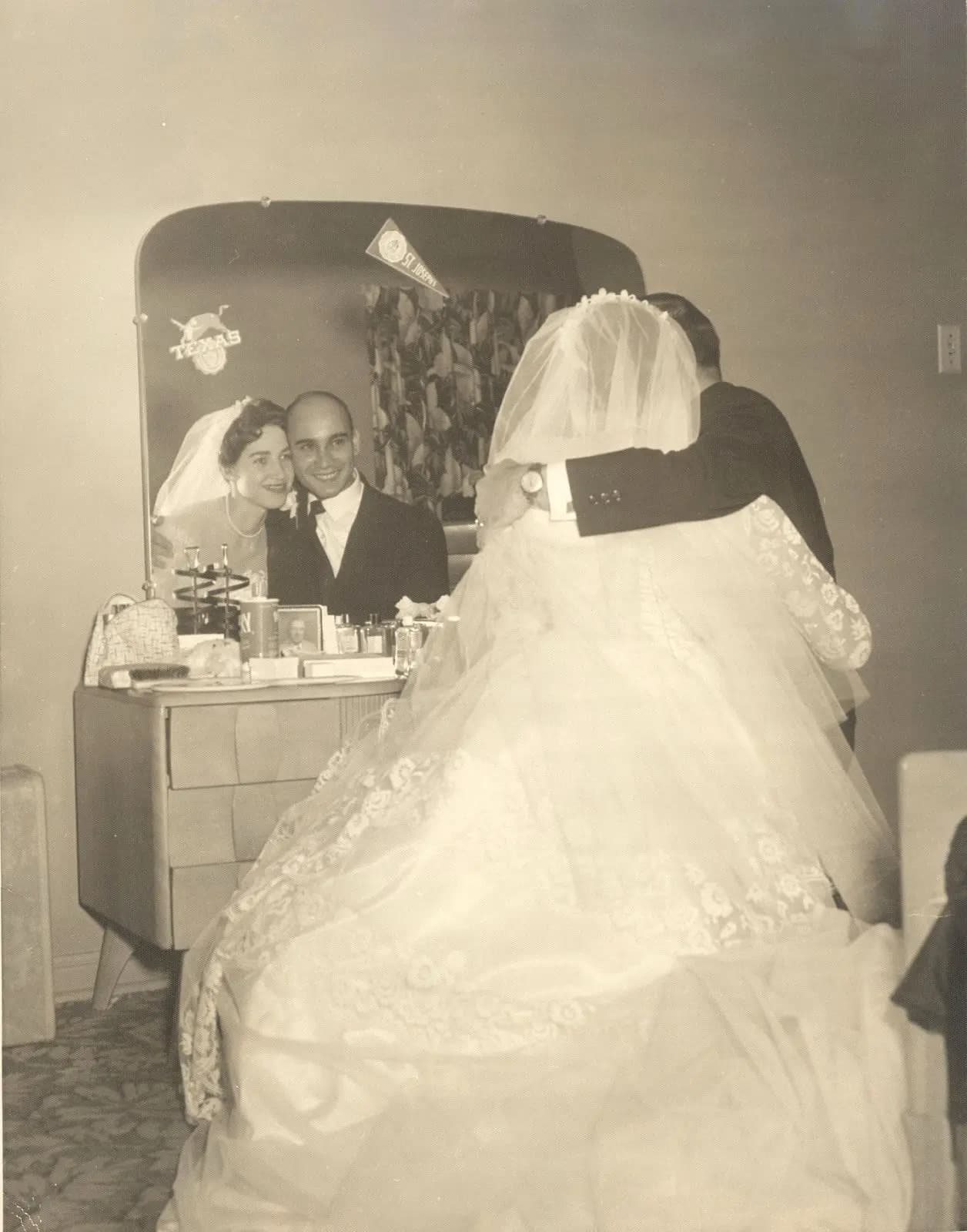 Vintage photo of a bride and groom reflected in a vanity mirror