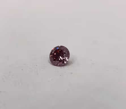 Rose pink diamond on white backdrop.