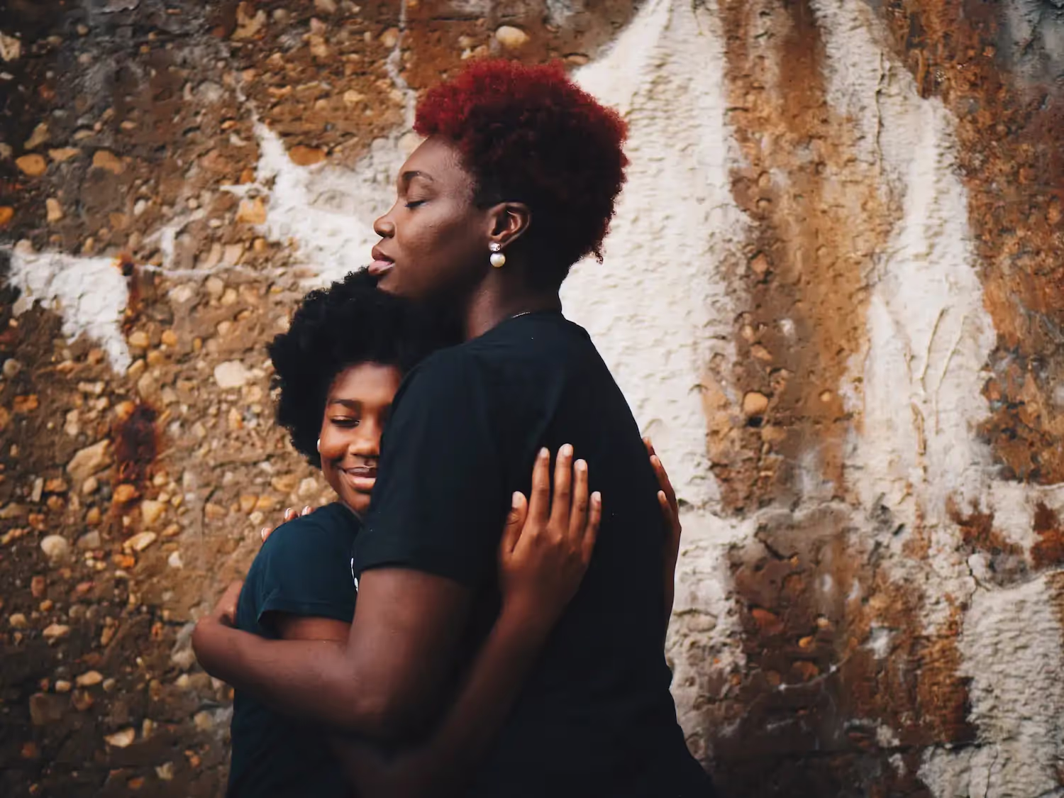 A woman hugging her child.