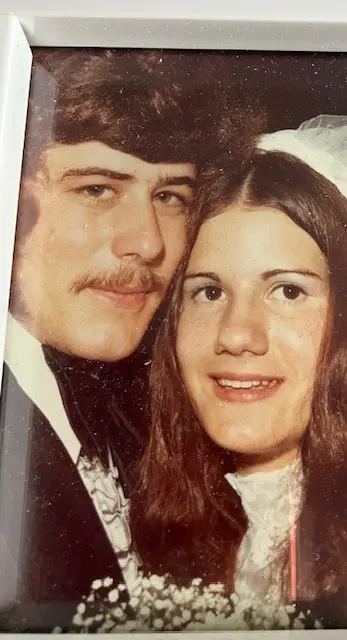 Close-up vintage portrait of Nancy and Steve as newlyweds, Nancy in a veil.
