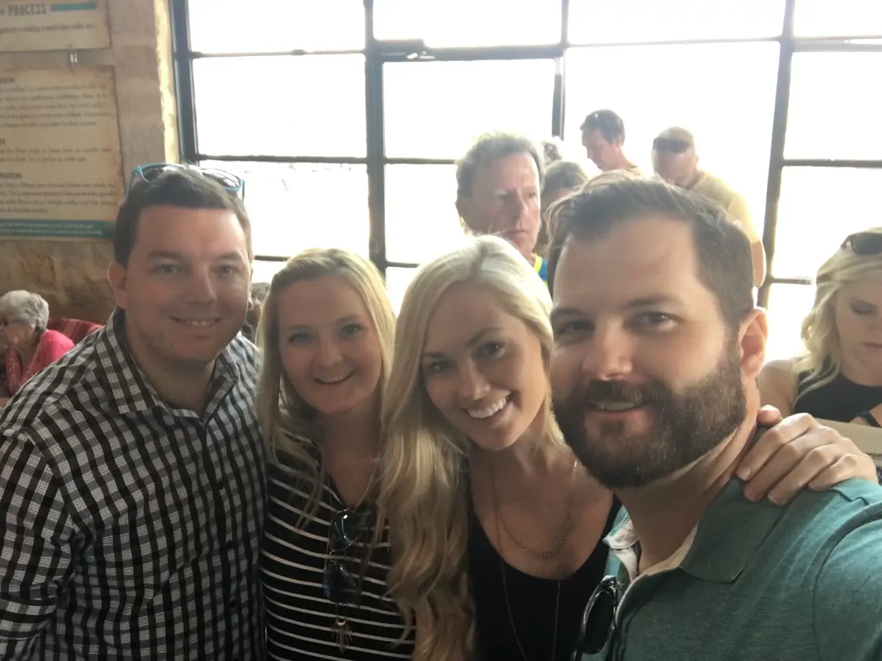 Group selfie of smiling friends and family at a crowded gathering