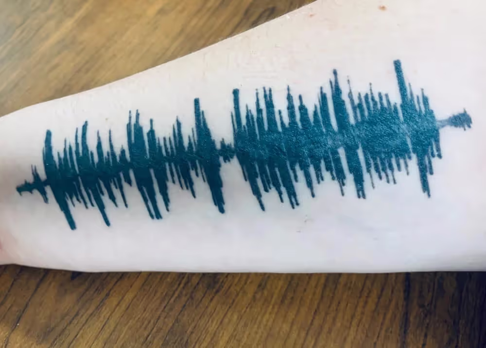 Sound wave of mother's voice tattooed on arm.