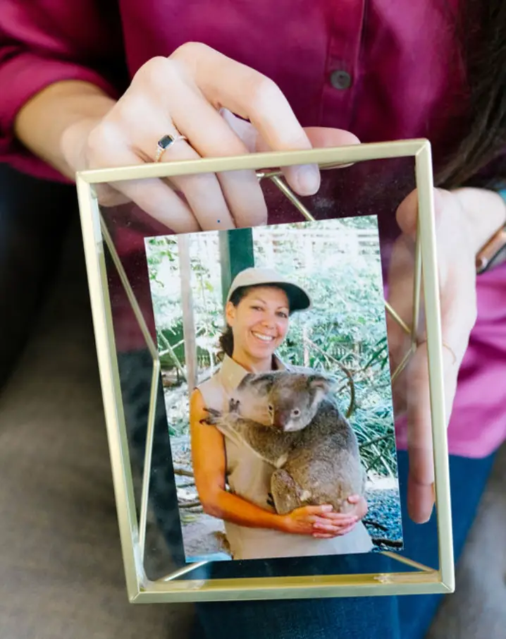 Photo of woman holding a koala.