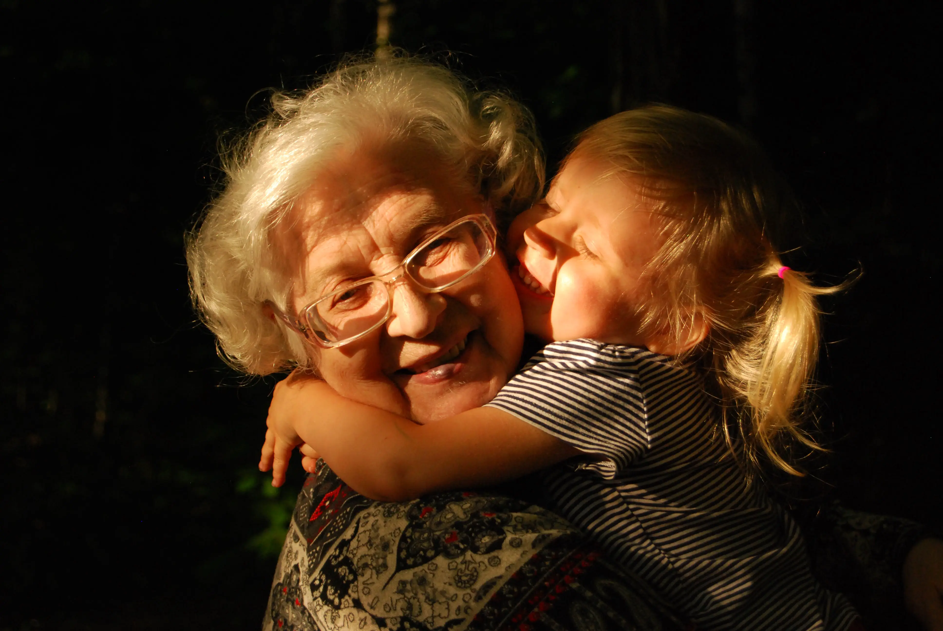 Grandmother and young granddaughter sharing a warm hug