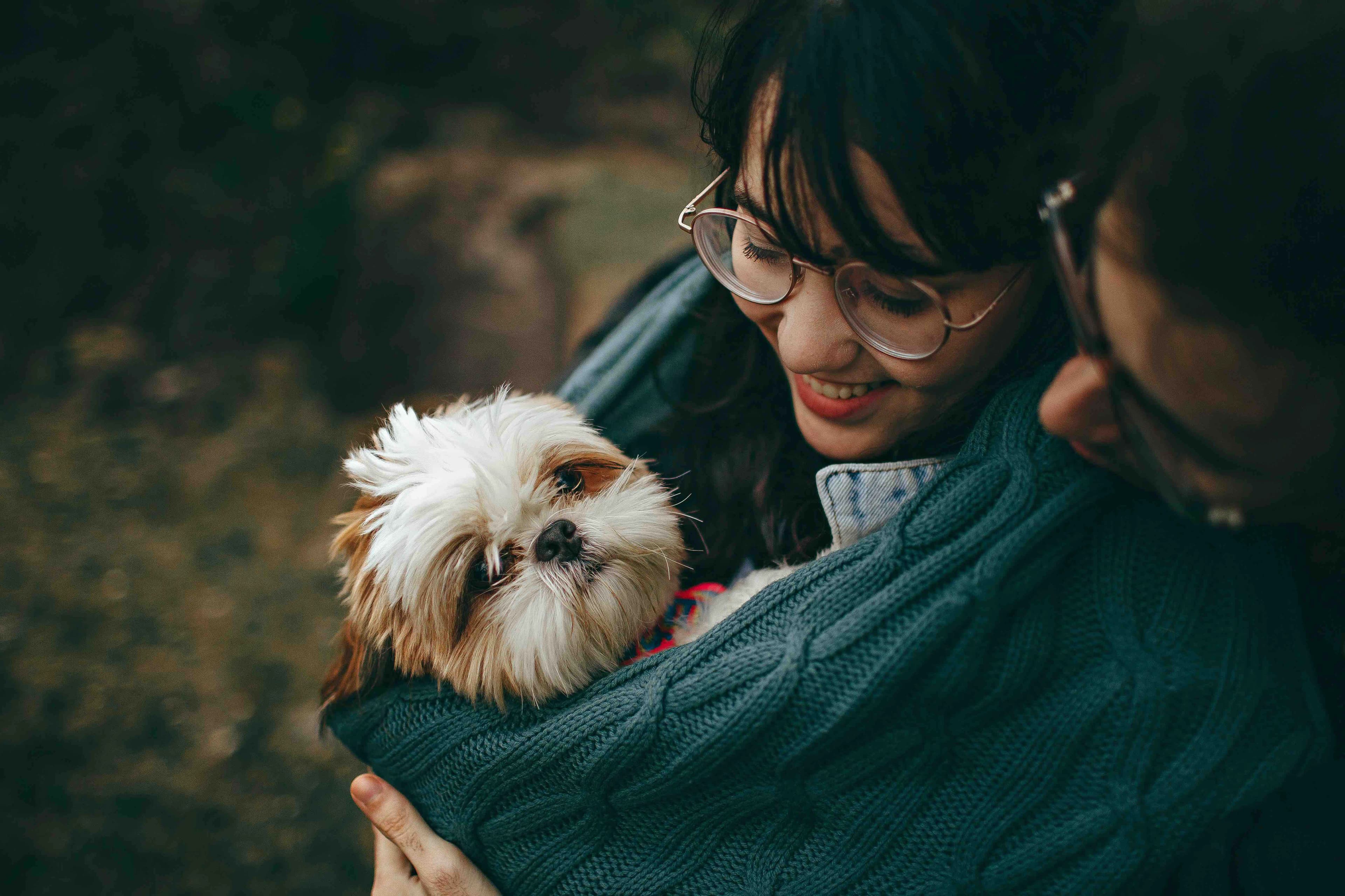 couple cuddles a cute dog