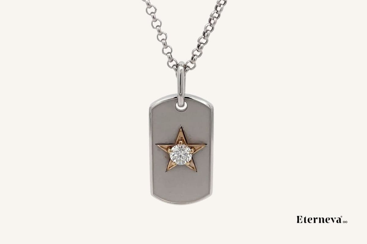 An Eterneva dog tag necklace: a silver pendant with a gold star design and a memorial diamond set in the centre.