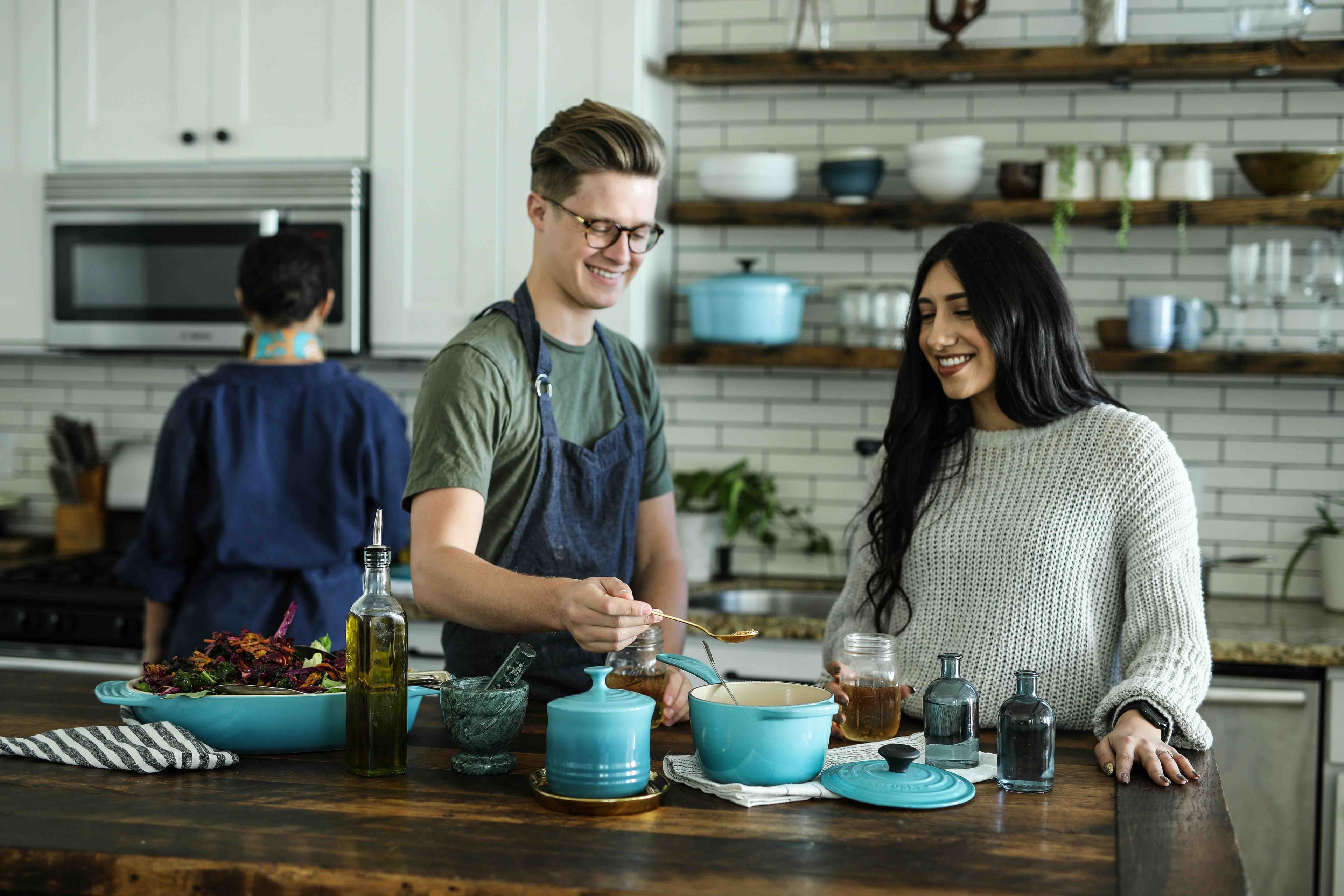 man and woman enjoy a cooking class together